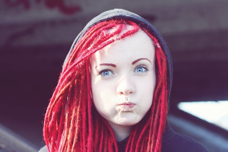person with red dreadlocks