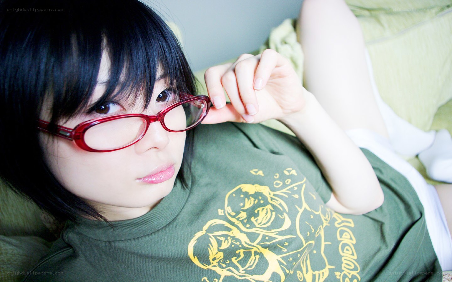 person with red glasses lying down