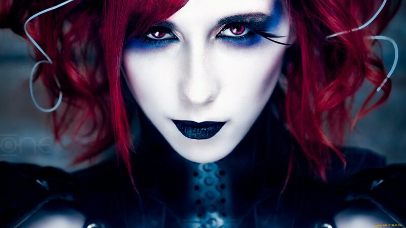 person with red hair and dark makeup