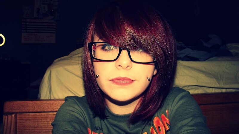 person with red hair and glasses