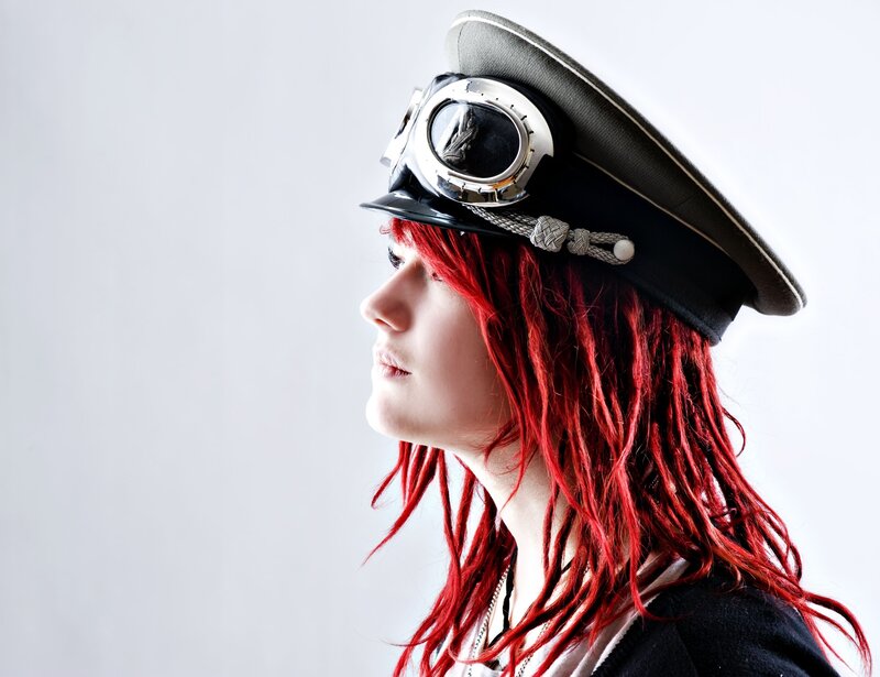 person with red hair and goggles