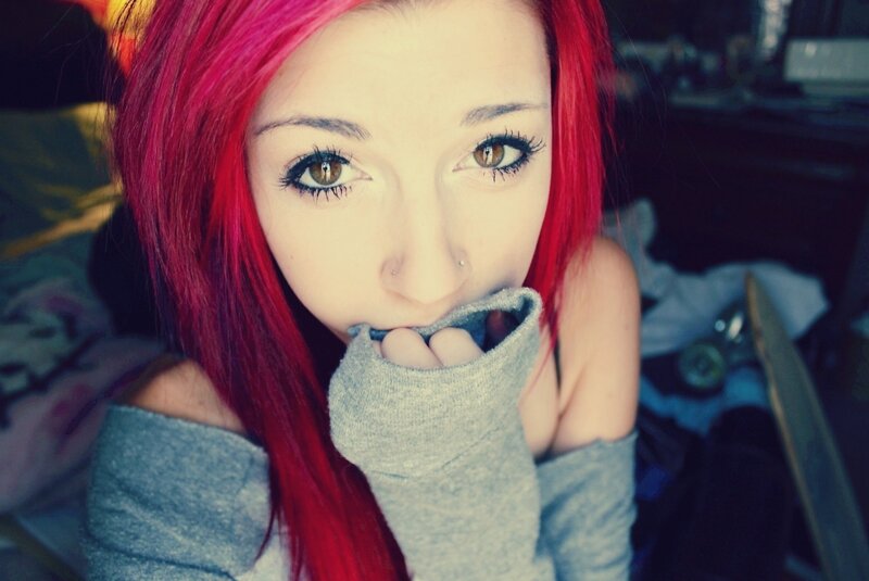 person with red hair and grey sweater