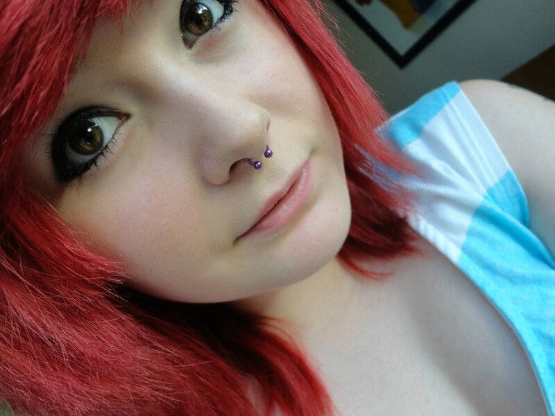 person with red hair and nose piercing