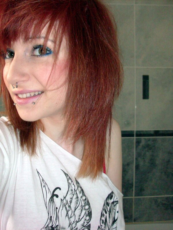 person with red hair and piercings