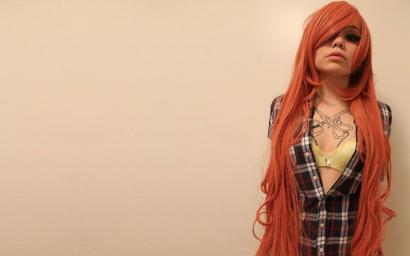person with red hair and plaid shirt