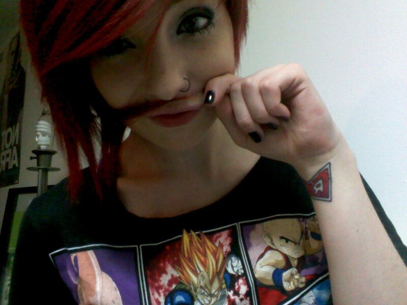 person with red hair and tattoos