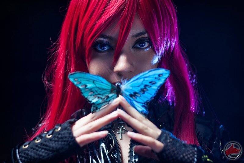 person with red hair holding butterfly