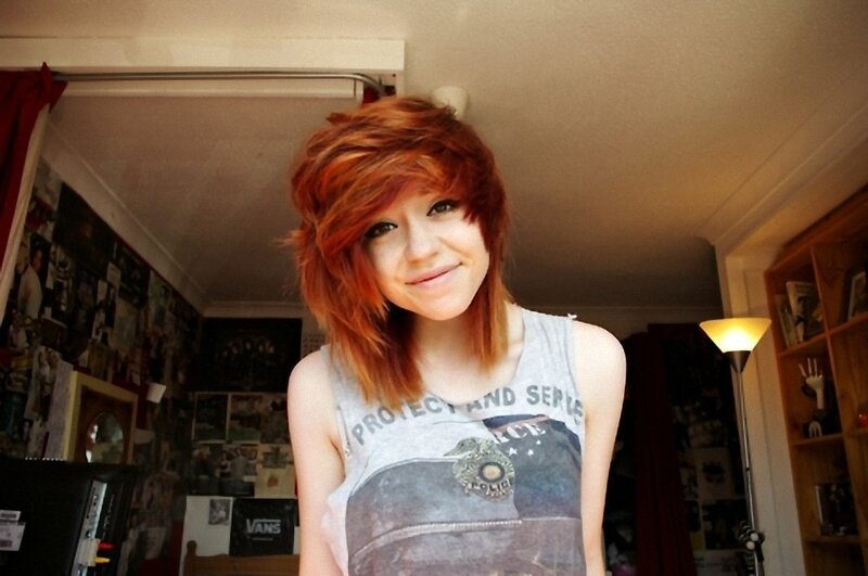 person with red hair in bedroom