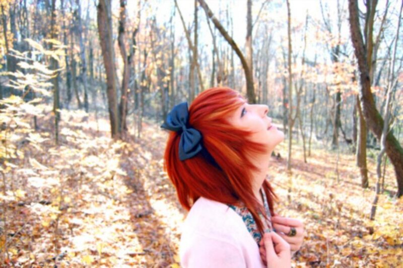 Person with Red Hair in Forest
