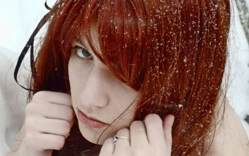 person with red hair in snow