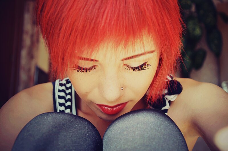 person with red hair looking down