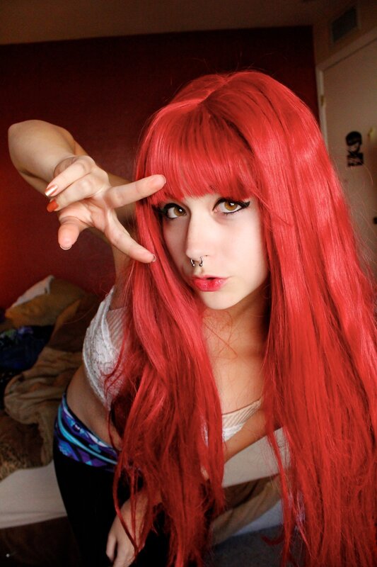 person with red hair making hand gesture
