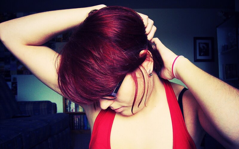 person with red hair styling