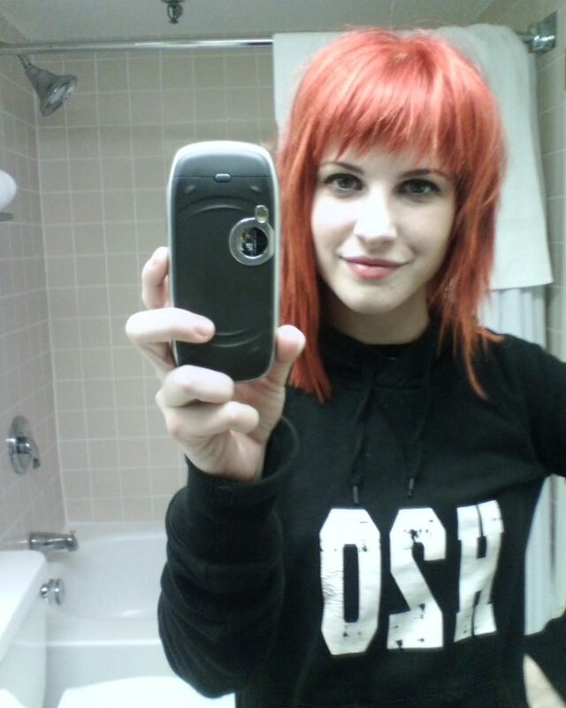person with red hair taking selfie