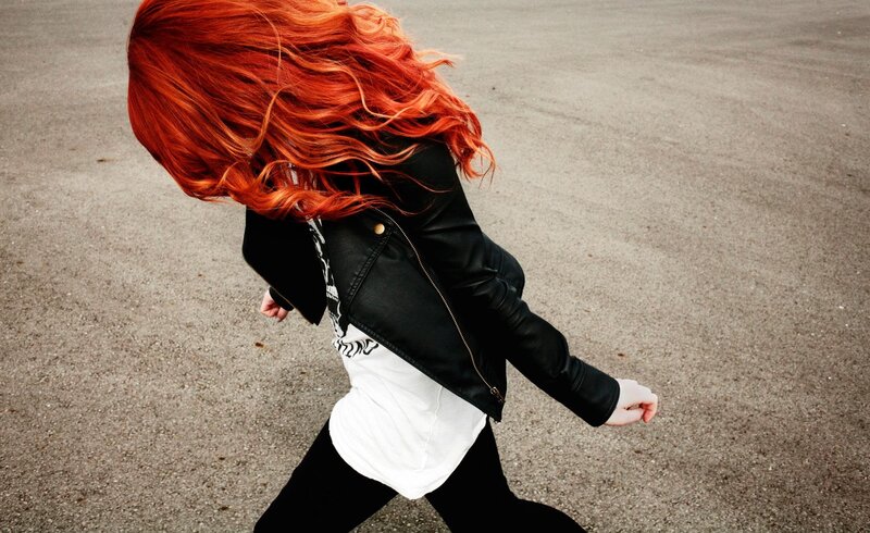 person with red hair walking
