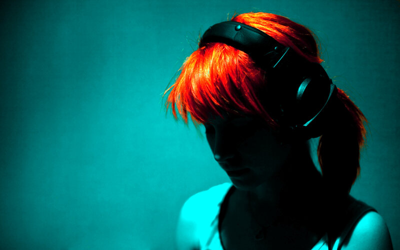person with red hair wearing headphones