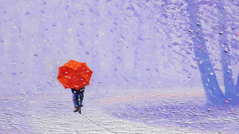 Person with red umbrella in snow