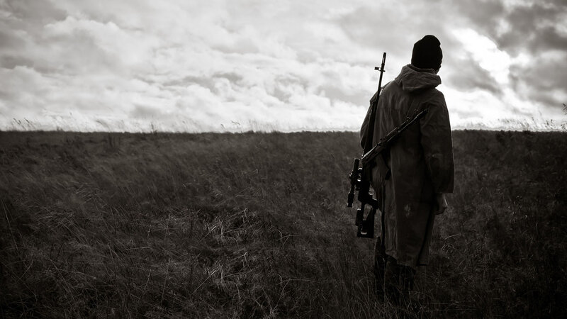 Person with Rifle in Field — Black, Dramatic