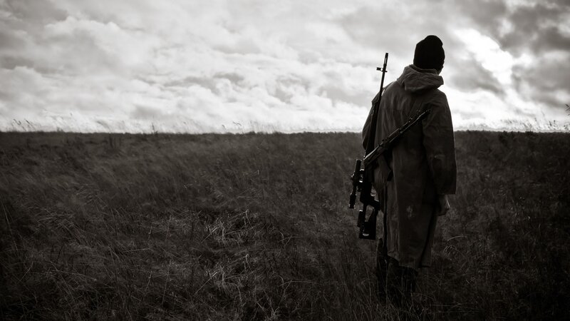 Person with Rifle in Field — Black