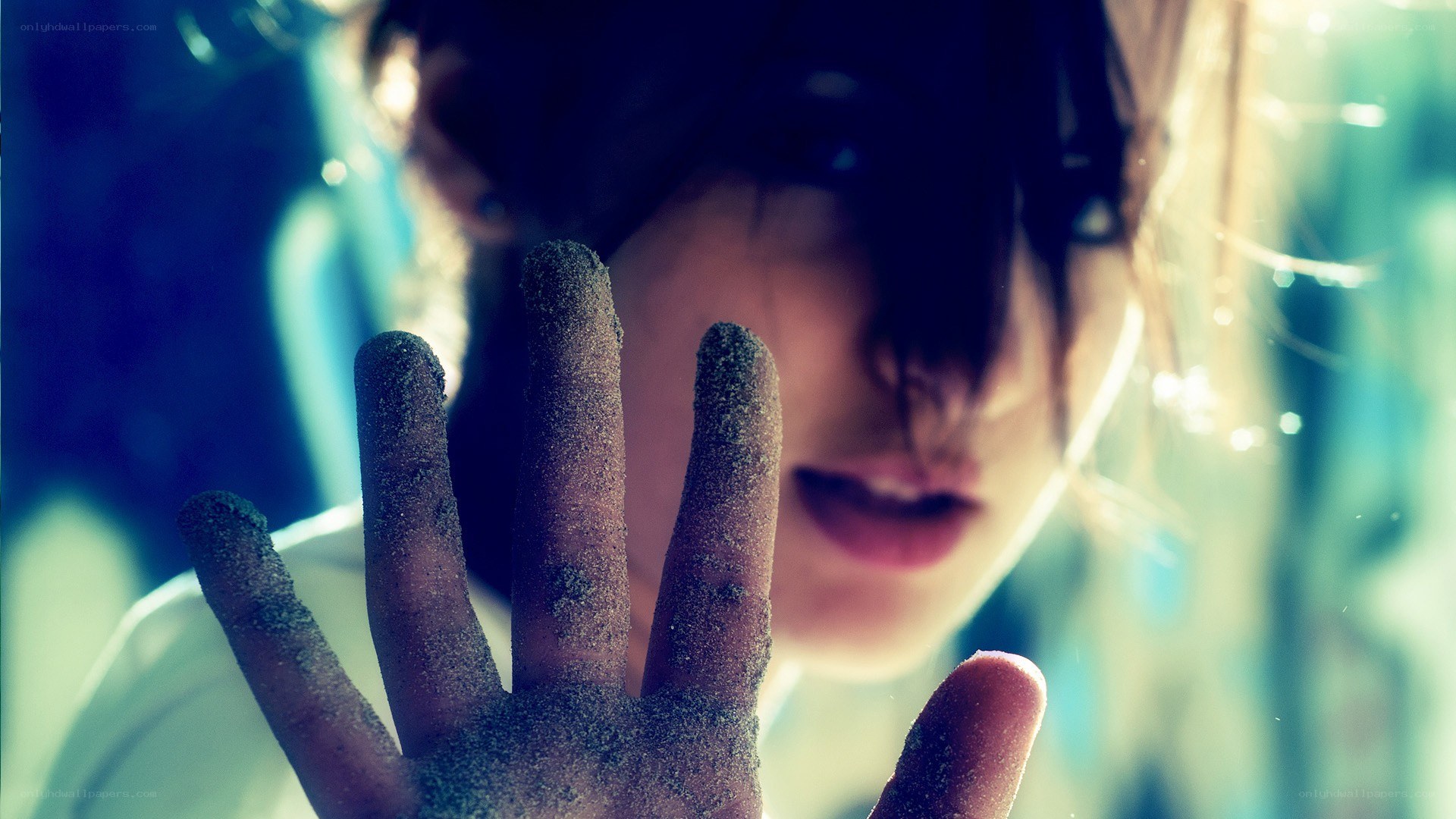 person with sand on hand