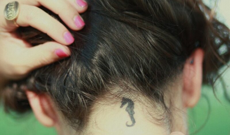 person with seahorse tattoo