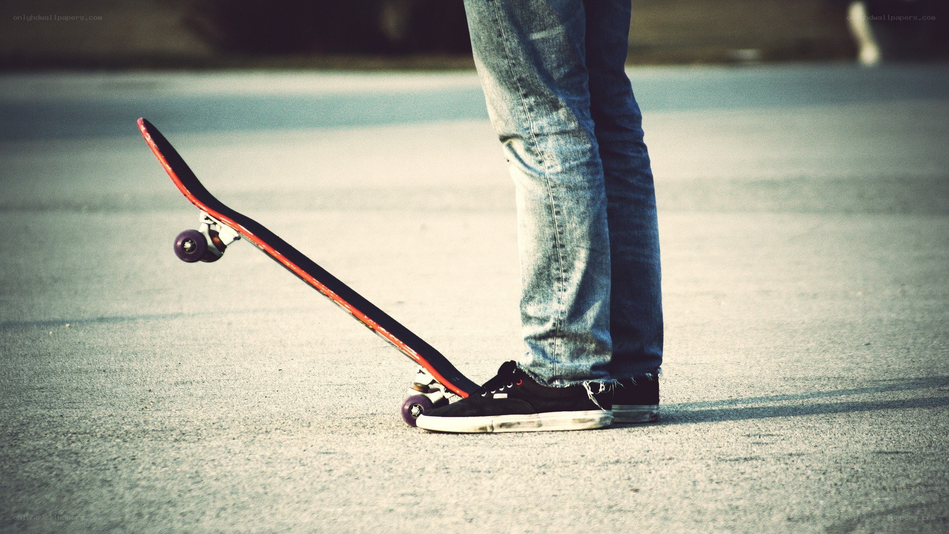 person with skateboard on pavement