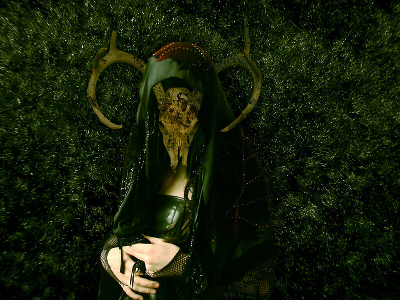 person with skull mask and antlers