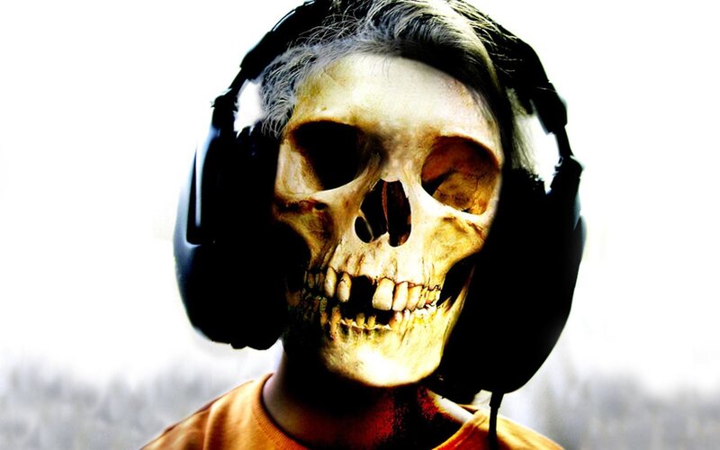 person with skull mask and headphones