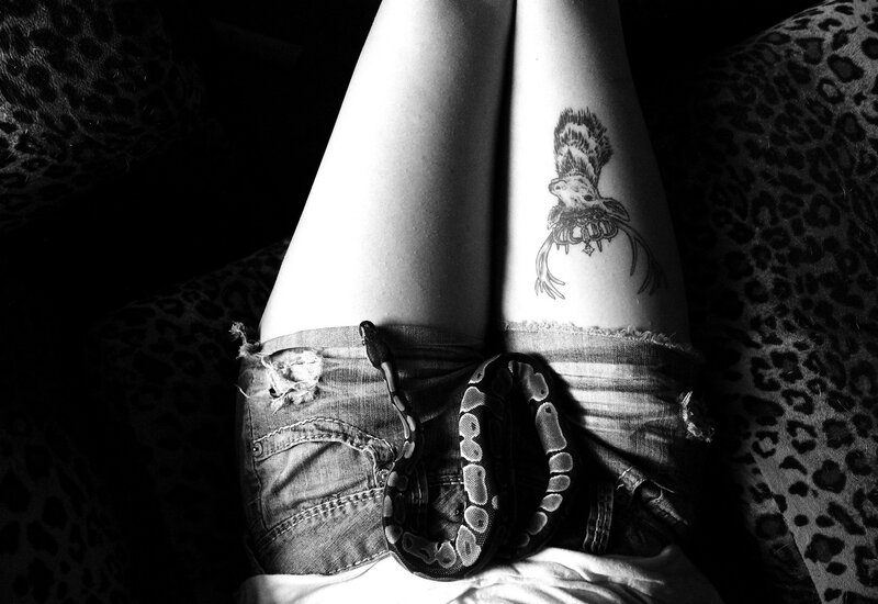 person with snake and tattoo