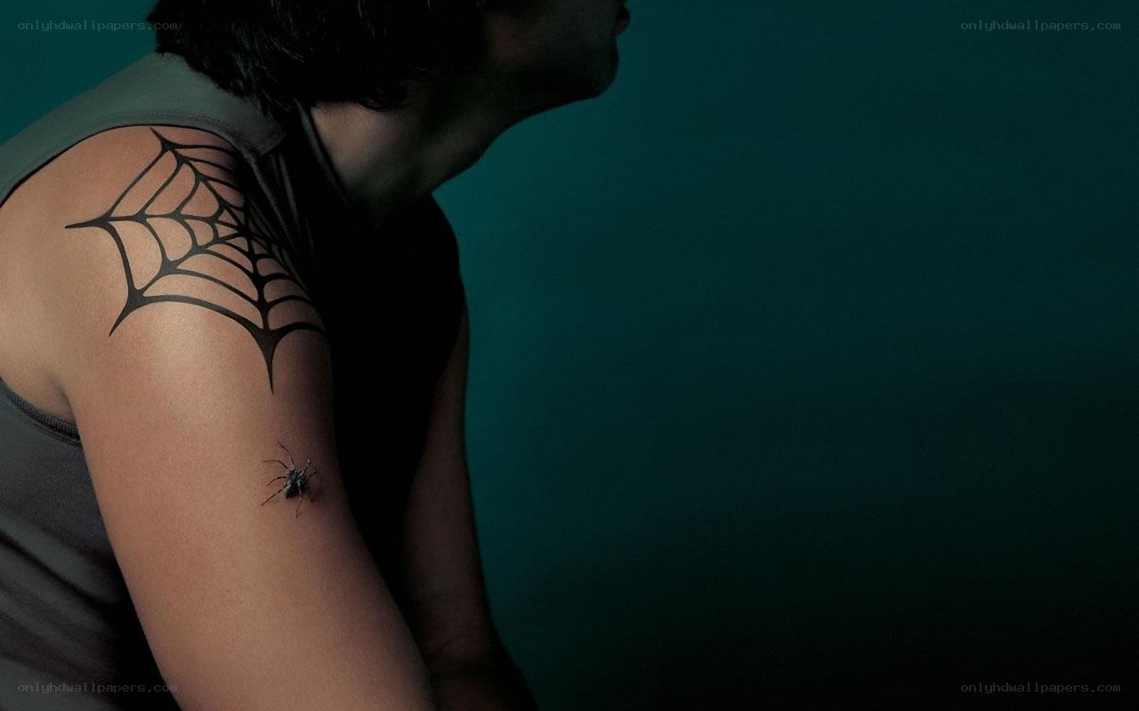 person with spider web tattoo