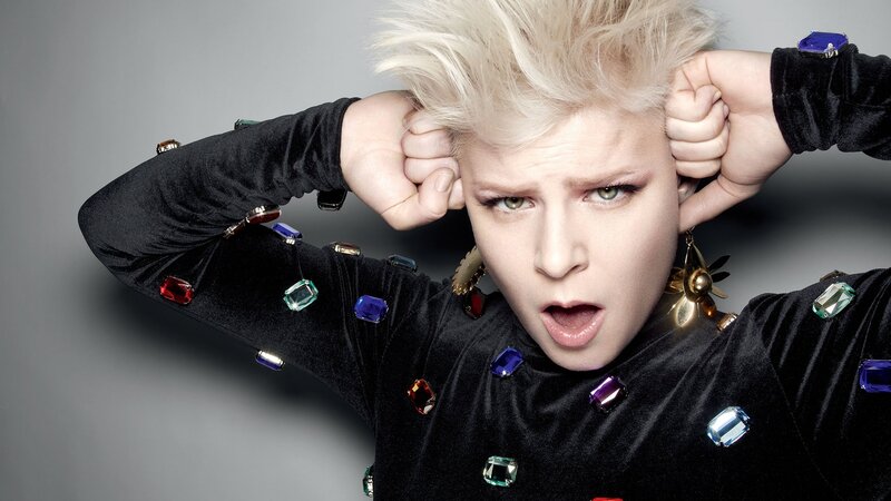 person with spiky hair and colorful gems