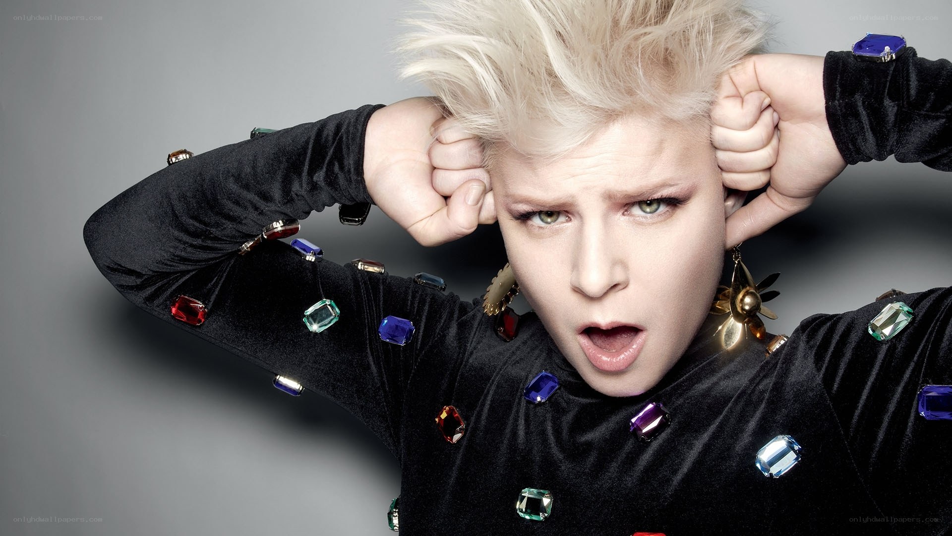 person with spiky hair and colorful gems