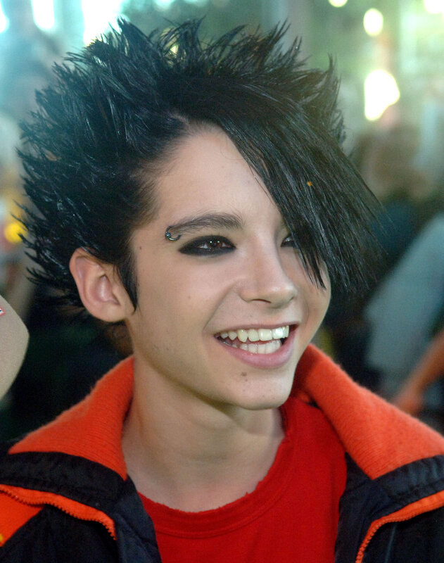 person with spiky hair smiling