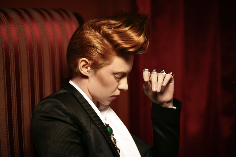 person with styled hair in suit