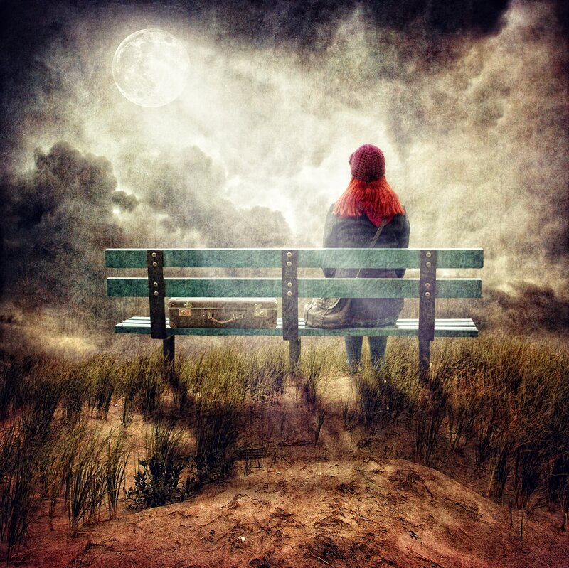 Person with Suitcase on Bench
