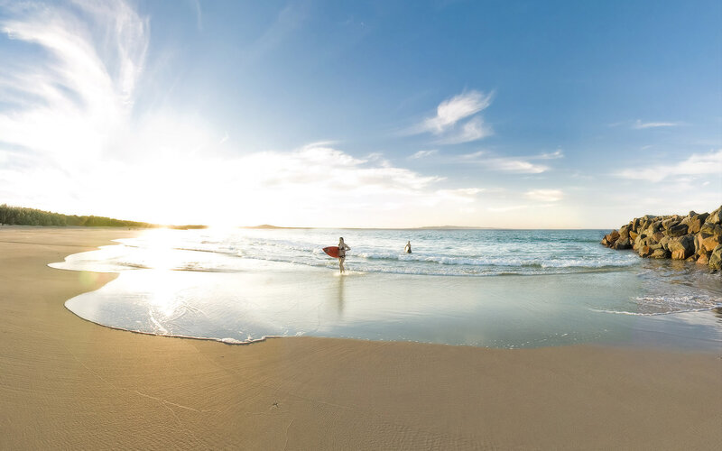 Person with Surfboard on Beach