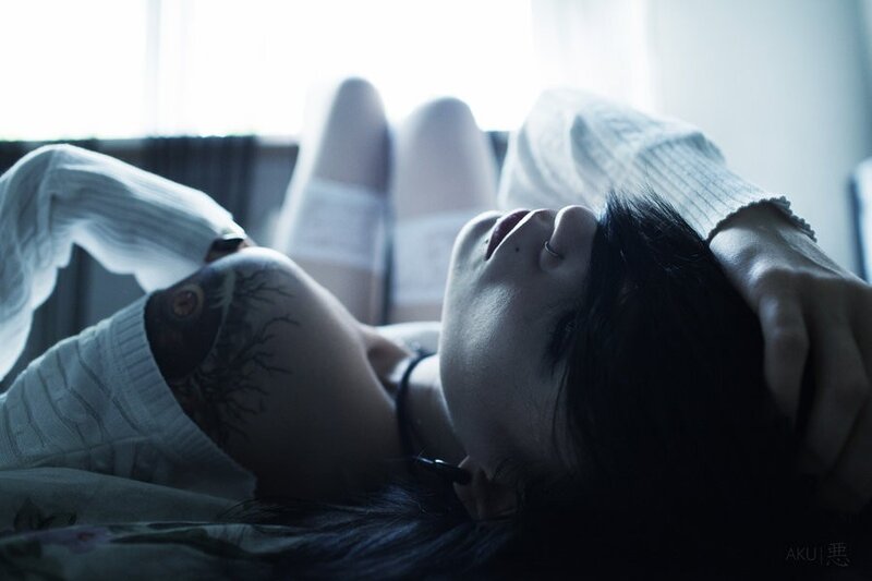person with tattoo lying down
