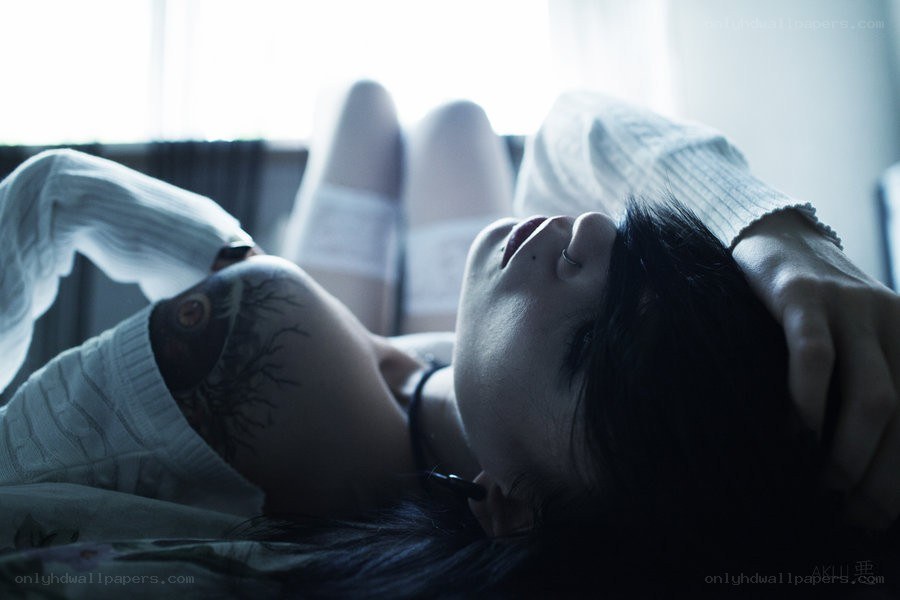 person with tattoo lying down