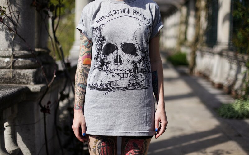 person with tattooed arms