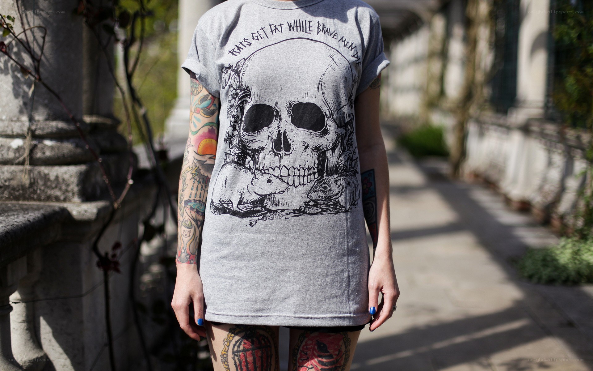 person with tattooed arms