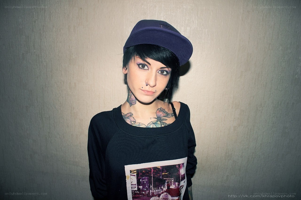 person with tattoos and cap