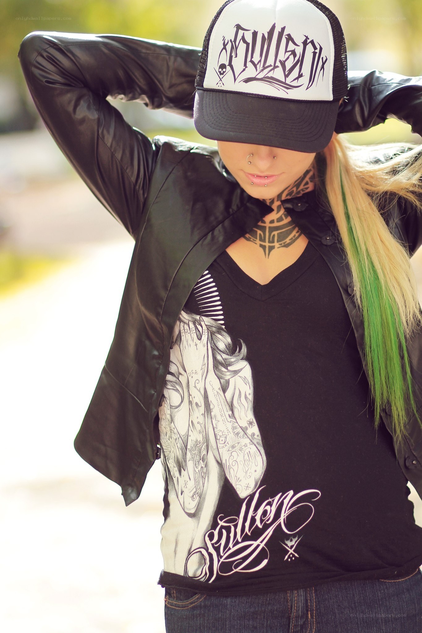 person with tattoos and cap