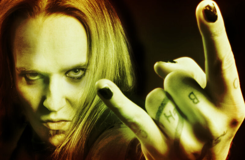 person with tattoos and dark makeup