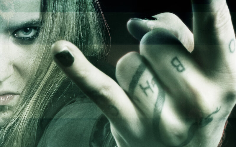 person with tattoos and dark makeup