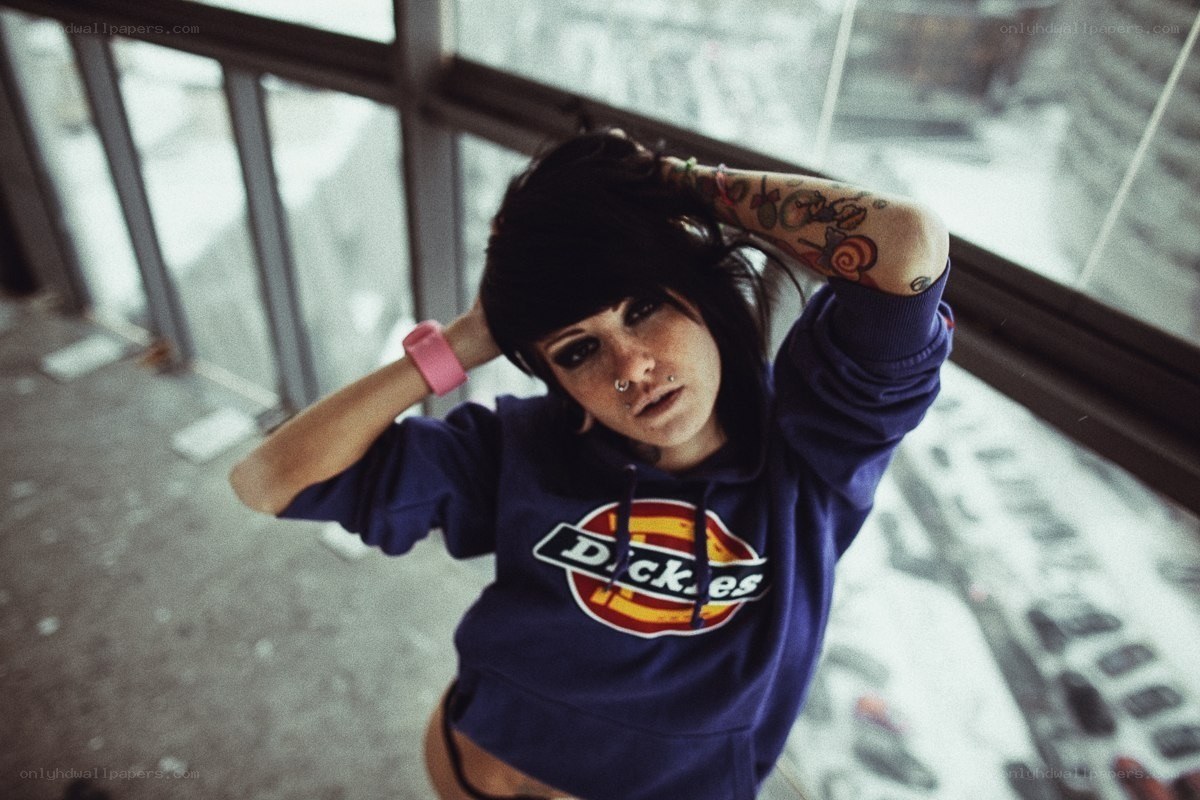 person with tattoos and piercings