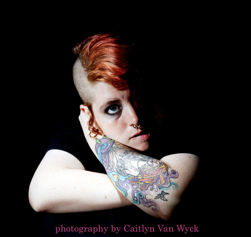 person with tattoos and red hair