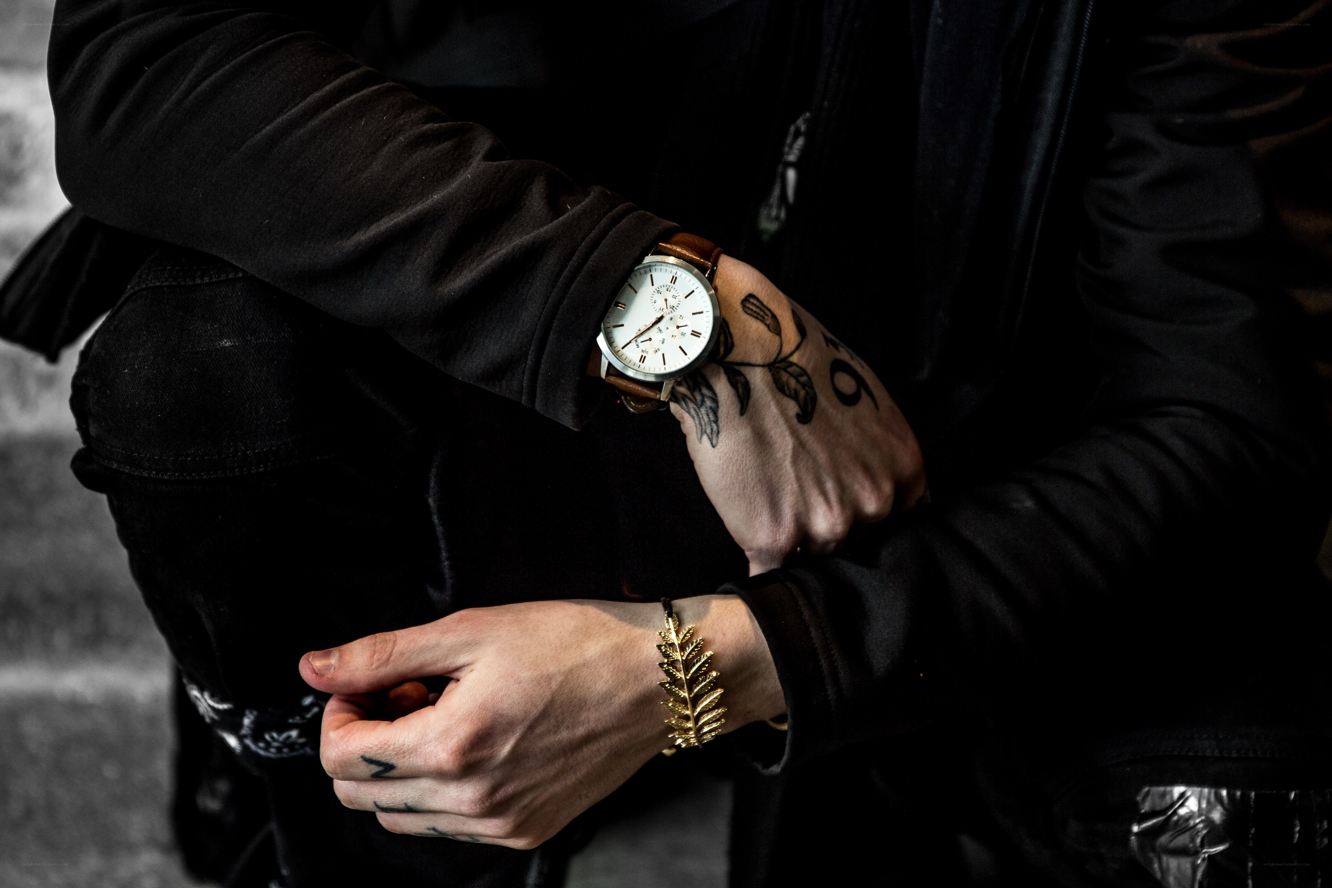 person with tattoos and watch