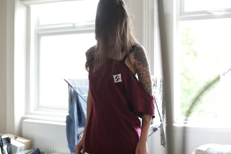 person with tattoos in a room