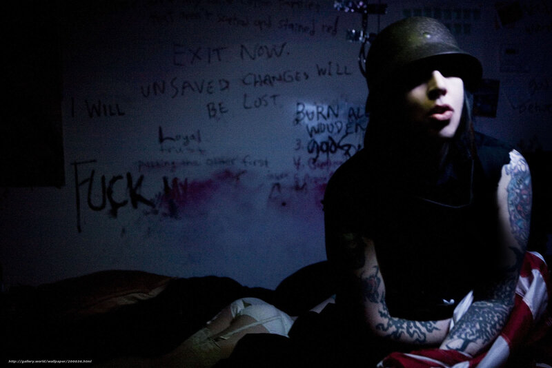 person with tattoos in dark room