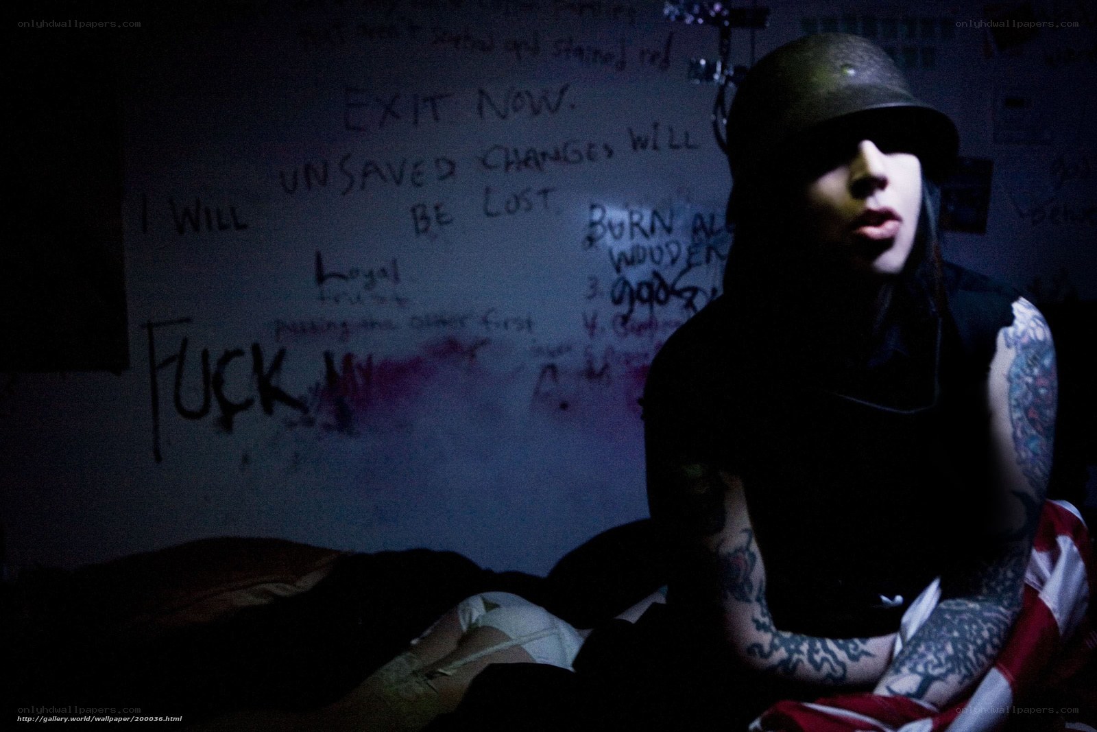person with tattoos in dark room